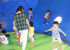 風船の遊具で遊ぶ親子の写真